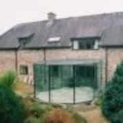 curved glass structure with faceted walls 