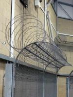 Utility fence toppings present razor wire only when climbed