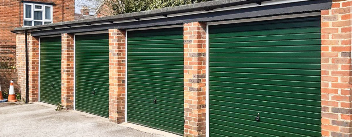 A Row of Four Garador Horizon Steel Up & Over Garage Doors Finished in Moss Green
