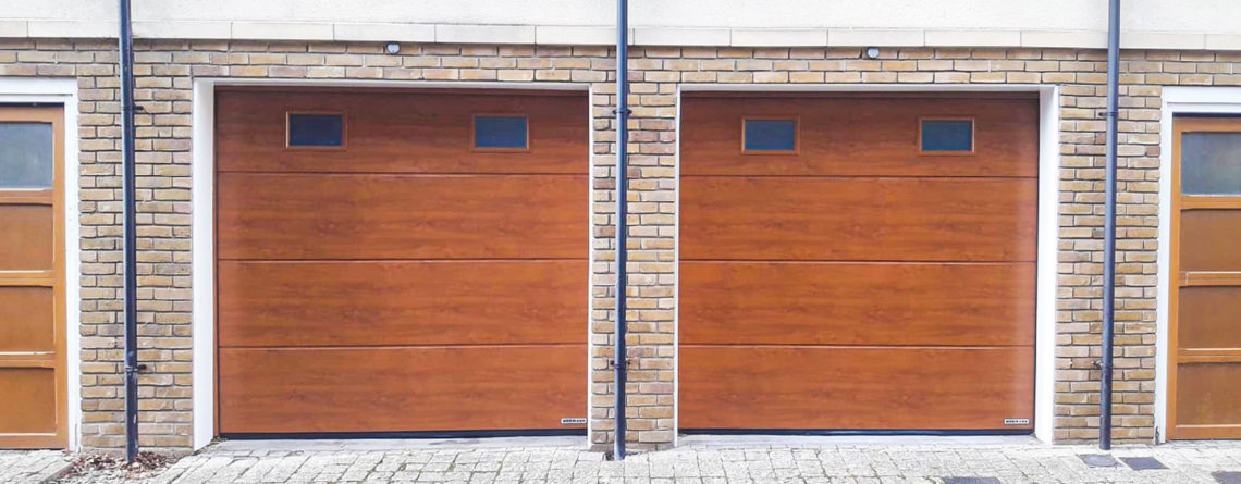 Hormann LPU42 L-Ribbed Insulated Sectional Garage Doors With Windows in Golden Oak Decograin