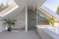 Rooflights And Roof Windows Used In Bungalow Renovation To Take Advantage Of Spectacular Sights