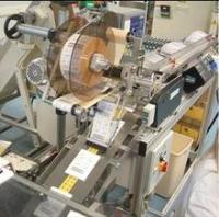 Precision Labelling and Timed Feed into Cartoning Machine