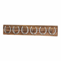Six Nickel Finish Metal Horse Shoe Hooks On Brown Wooden Board